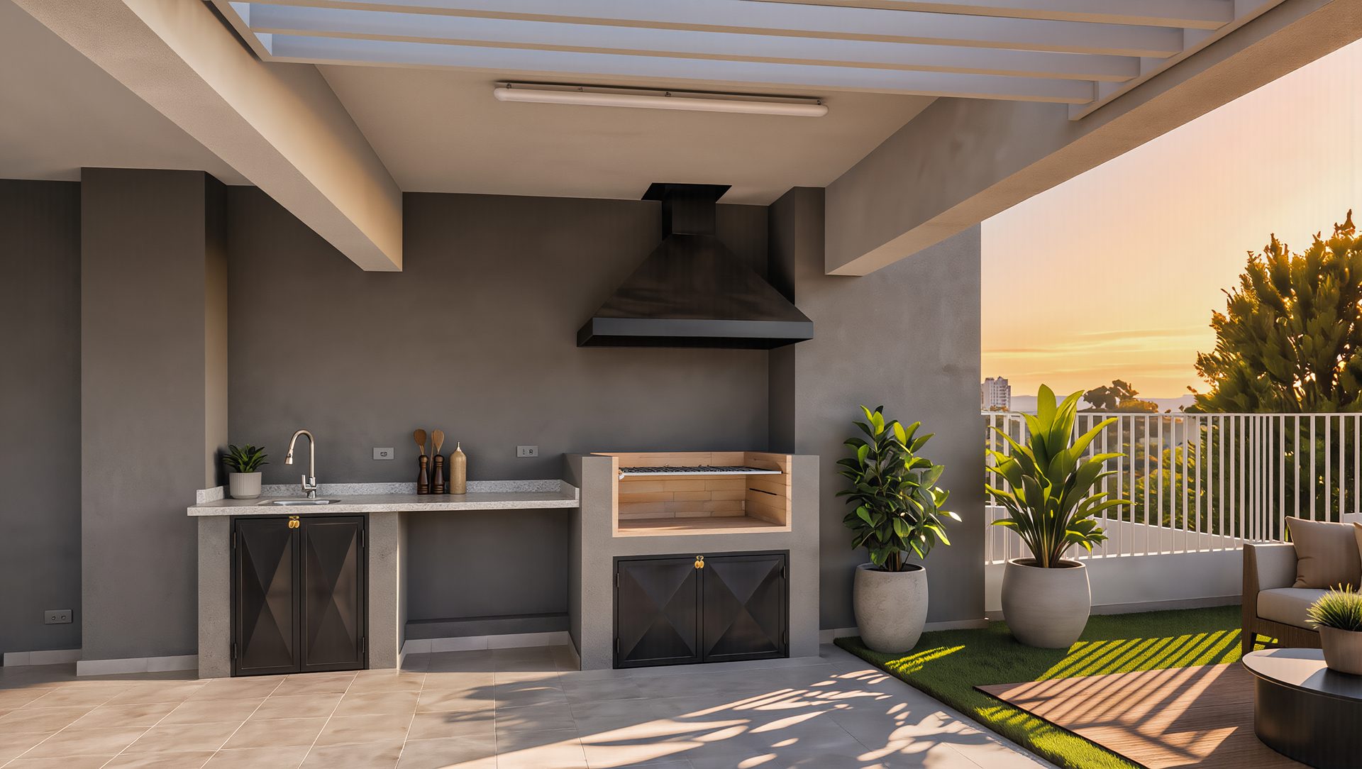 Quincho privado del Penthouse visto de frente al atardecer: mesón con lavaplatos, campana y parrilla